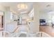 Bright kitchen with white cabinets, appliances, tile floor and eat in breakfast nook at 7499 Blue Skies Dr, Spring Hill, FL 34606