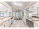 Bright kitchen with white cabinetry, a breakfast nook, tile floors, and lots of natural light at 7499 Blue Skies Dr, Spring Hill, FL 34606