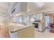 Spacious kitchen with breakfast bar, white cabinetry, and modern appliances at 7499 Blue Skies Dr, Spring Hill, FL 34606