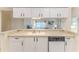 The kitchen offers ample counter space and updated appliances, including a dishwasher at 7499 Blue Skies Dr, Spring Hill, FL 34606