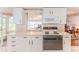 The white kitchen features plenty of cabinet space and modern appliances at 7499 Blue Skies Dr, Spring Hill, FL 34606