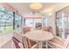 Cozy lanai featuring durable flooring, a ceiling fan, comfortable seating, and serene views of the outdoors at 7499 Blue Skies Dr, Spring Hill, FL 34606