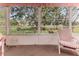 View from the lanai shows well-maintained lawns and trees enhancing the outdoor living experience in Spring Hill at 7499 Blue Skies Dr, Spring Hill, FL 34606