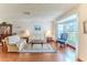 Inviting living room with hardwood floors and a large window providing natural light at 7499 Blue Skies Dr, Spring Hill, FL 34606