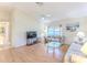 The living room features a ceiling fan, vaulted ceilings, and wood-look flooring at 7499 Blue Skies Dr, Spring Hill, FL 34606