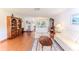 Bright living room showcasing hardwood floors, natural light, and comfortable seating arrangement at 7499 Blue Skies Dr, Spring Hill, FL 34606