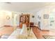 Spacious living room with hardwood floors and view into kitchen at 7499 Blue Skies Dr, Spring Hill, FL 34606