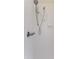Shower with white tiled walls, a handheld showerhead, and a grab bar at 7499 Blue Skies Dr, Spring Hill, FL 34606
