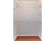 Empty walk-in closet with wire shelving on the walls and wood floors at 7499 Blue Skies Dr, Spring Hill, FL 34606