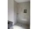 Elegant bathroom featuring a tiled shower with a niche, a corner shelf, and neutral, modern decor at 7583 St Andrews Blvd, Weeki Wachee, FL 34613
