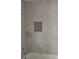 The bathroom features tiled walls, a convenient shelf, and a bathtub, perfect for relaxing after a long day at 7583 St Andrews Blvd, Weeki Wachee, FL 34613
