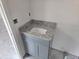 Bathroom vanity with a white sink, grey cabinets, and granite countertops, under construction at 7583 St Andrews Blvd, Weeki Wachee, FL 34613
