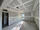 Unfinished bedroom featuring a coffered ceiling design, natural light from windows, and ready for personalization at 7583 St Andrews Blvd, Weeki Wachee, FL 34613