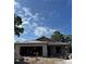 New construction shows concrete walls and roofline against a partially cloudy sky on a sunny day at 7583 St Andrews Blvd, Weeki Wachee, FL 34613