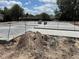 Image features the concrete foundation of the building, illustrating new construction and landscaping at 7583 St Andrews Blvd, Weeki Wachee, FL 34613
