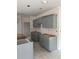 Unfinished kitchen with gray cabinets being installed, showcasing the modern design and layout of the space at 7583 St Andrews Blvd, Weeki Wachee, FL 34613