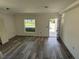 This living room boasts new hardwood floors, fresh paint, and a large window, ready for personalization at 7583 St Andrews Blvd, Weeki Wachee, FL 34613