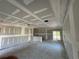 Unfinished living room showing a coffered ceiling, drywall, and an open layout with natural light from windows at 7583 St Andrews Blvd, Weeki Wachee, FL 34613