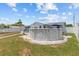 Large backyard with above-ground pool, white rock features, and beautiful landscaping at 7626 Hatteras Dr, Hudson, FL 34667