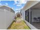 Fenced backyard features shed and view into screened in lanai for easy access at 7626 Hatteras Dr, Hudson, FL 34667