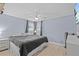 Bedroom with light blue walls, ceiling fan, and light hardwood floors at 7626 Hatteras Dr, Hudson, FL 34667
