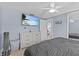 Bedroom with dresser, ceiling fan, and TV mounted to the wall at 7626 Hatteras Dr, Hudson, FL 34667