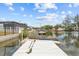 Waterfront property featuring a private dock with kayaks and easy access to the serene canal waters at 7626 Hatteras Dr, Hudson, FL 34667