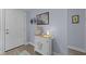 Inviting entryway with stylish decor, featuring a charming cabinet with a turtle accent and nautical-themed artwork at 7626 Hatteras Dr, Hudson, FL 34667