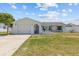Charming single-story home featuring a well-manicured lawn, a garage, and beautiful stone accents enhancing its curb appeal at 7626 Hatteras Dr, Hudson, FL 34667