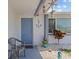 Welcoming front porch with nautical decor, a cozy chair, and decorative accents, creating a charming entrance at 7626 Hatteras Dr, Hudson, FL 34667
