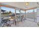Enclosed lanai with tiled floors offers waterfront views and seating area for relaxation at 7626 Hatteras Dr, Hudson, FL 34667