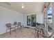 Covered outdoor space with tile flooring and multiple seating options for dining and entertaining at 7626 Hatteras Dr, Hudson, FL 34667