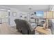 Bright living room featuring a television, coastal decor, and an open floor plan to the kitchen and dining area at 7626 Hatteras Dr, Hudson, FL 34667