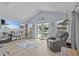 Living space showcasing a television, sliding glass doors to the pool, and a comfortable recliner and dining area at 7626 Hatteras Dr, Hudson, FL 34667