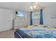 Main bedroom with ceiling fan, dresser, TV and ensuite bathroom at 7626 Hatteras Dr, Hudson, FL 34667