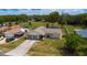 Aerial view of the home with a well-manicured lawn and landscaping at 8126 Wooden Dr, Spring Hill, FL 34606