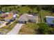 Aerial view of home with lush green lawn and mature trees at 8126 Wooden Dr, Spring Hill, FL 34606