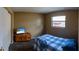 Cozy bedroom with wood floors, closet, TV, and blue and white bedding at 8126 Wooden Dr, Spring Hill, FL 34606