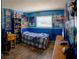 Blue bedroom, featuring desk, tv, blue plaid comforter, and decorations at 8126 Wooden Dr, Spring Hill, FL 34606