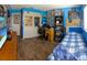Fully decorated blue bedroom, featuring shelves of collectables, desk, and TV at 8126 Wooden Dr, Spring Hill, FL 34606