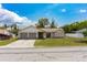 Charming single-story home with a two-car garage, well-maintained lawn, and mature trees at 8126 Wooden Dr, Spring Hill, FL 34606
