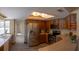 Spacious kitchen with wood cabinets, stainless steel refrigerator, and ample counter space at 8126 Wooden Dr, Spring Hill, FL 34606