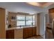 Bright kitchen featuring wood cabinetry, modern appliances, and a window view of the pool at 8126 Wooden Dr, Spring Hill, FL 34606