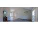 Bright living room features vaulted ceilings, updated flooring, and neutral paint scheme at 8126 Wooden Dr, Spring Hill, FL 34606