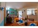 Cozy living room with dining area, hardwood floors, and sliding door access to pool at 8126 Wooden Dr, Spring Hill, FL 34606