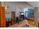 Spacious living room with ceiling fan, wood burning fire place, and view to dining area at 8126 Wooden Dr, Spring Hill, FL 34606