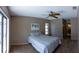 Relaxing bedroom with soft carpeting, a ceiling fan, and tranquil decor. Sliding glass doors to the pool at 8126 Wooden Dr, Spring Hill, FL 34606