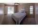 Calm bedroom with soft carpet and a ceiling fan. Sliding glass doors open to a private screened pool at 8126 Wooden Dr, Spring Hill, FL 34606