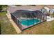 An aerial view of a screened-in pool offering a private and refreshing outdoor retreat at 8126 Wooden Dr, Spring Hill, FL 34606