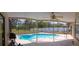Enjoy a refreshing dip in this screened-in private pool with a ceiling fan at 8126 Wooden Dr, Spring Hill, FL 34606